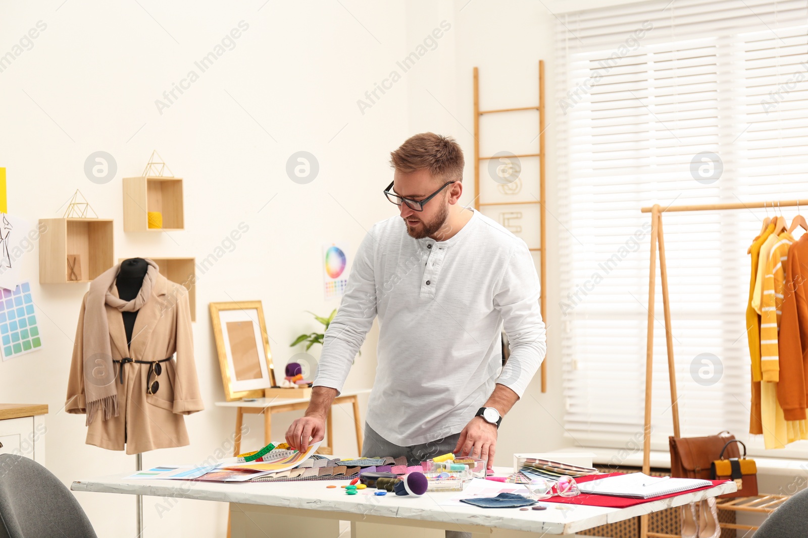 Photo of Fashion designer creating new clothes in studio