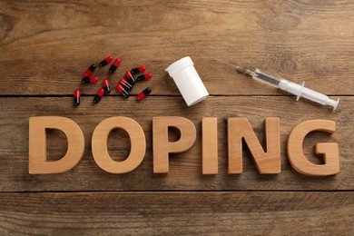 Photo of Word Doping and drugs on wooden background, flat lay