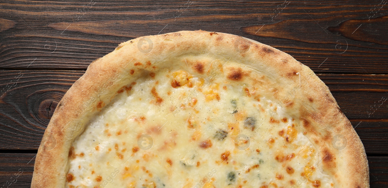 Photo of Delicious cheese pizza on wooden table, top view