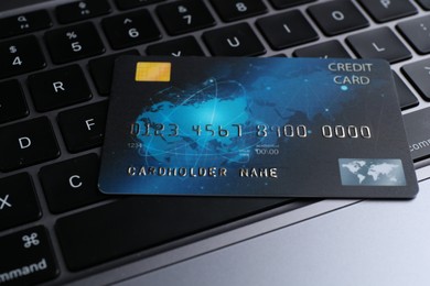 Photo of One plastic credit card on modern laptop