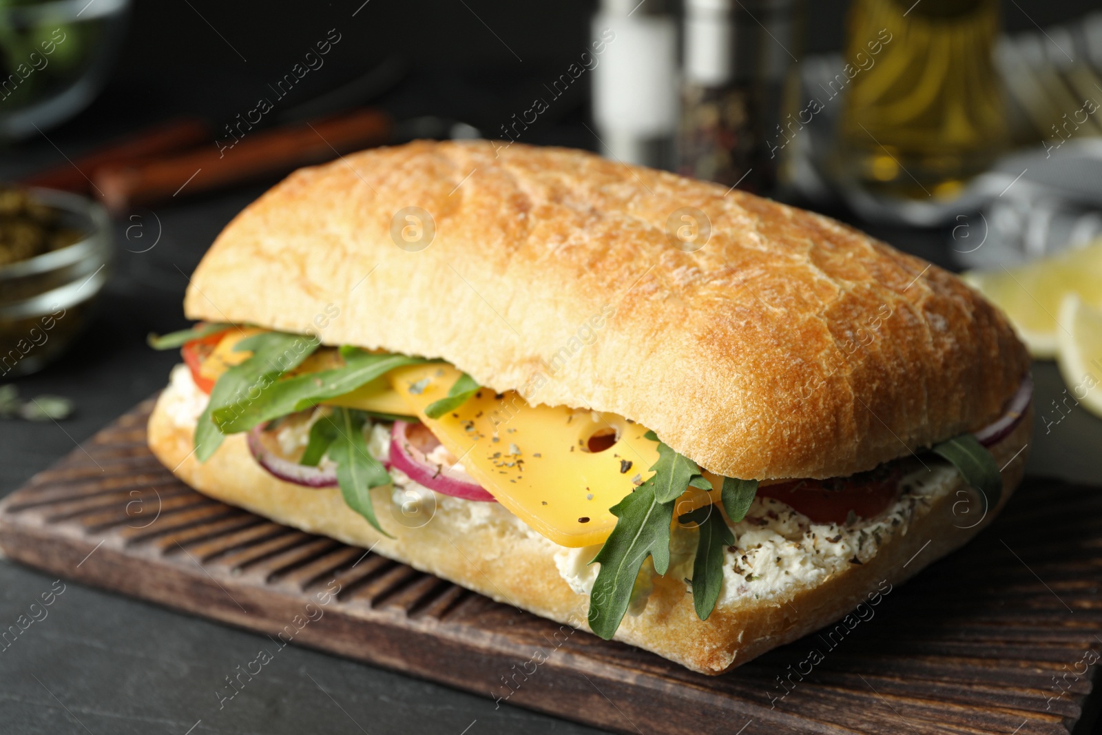 Photo of Delicious sandwich with fresh vegetables and cheese on grey table