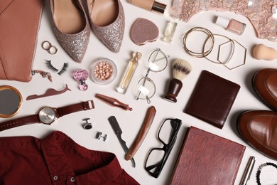 Photo of Flat lay composition with fashionable woman's and man's accessories on light background