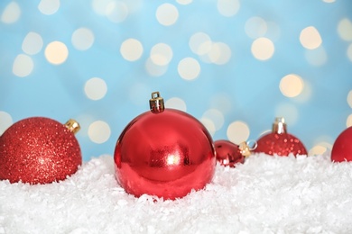 Christmas decoration on snow against blue background