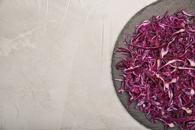 Photo of Plate with chopped red cabbage on light background, top view