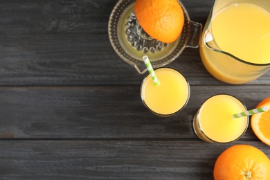 Photo of Flat lay composition with orange juice, fresh fruit and space for text on wooden background