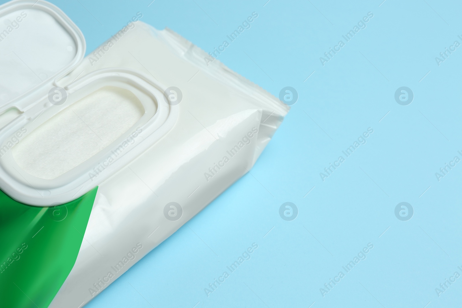 Image of Wet wipes flow pack on light blue background, closeup. Space for text