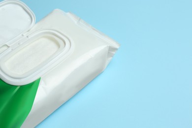 Image of Wet wipes flow pack on light blue background, closeup. Space for text