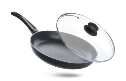 Image of New frying pan and glass lid on white background