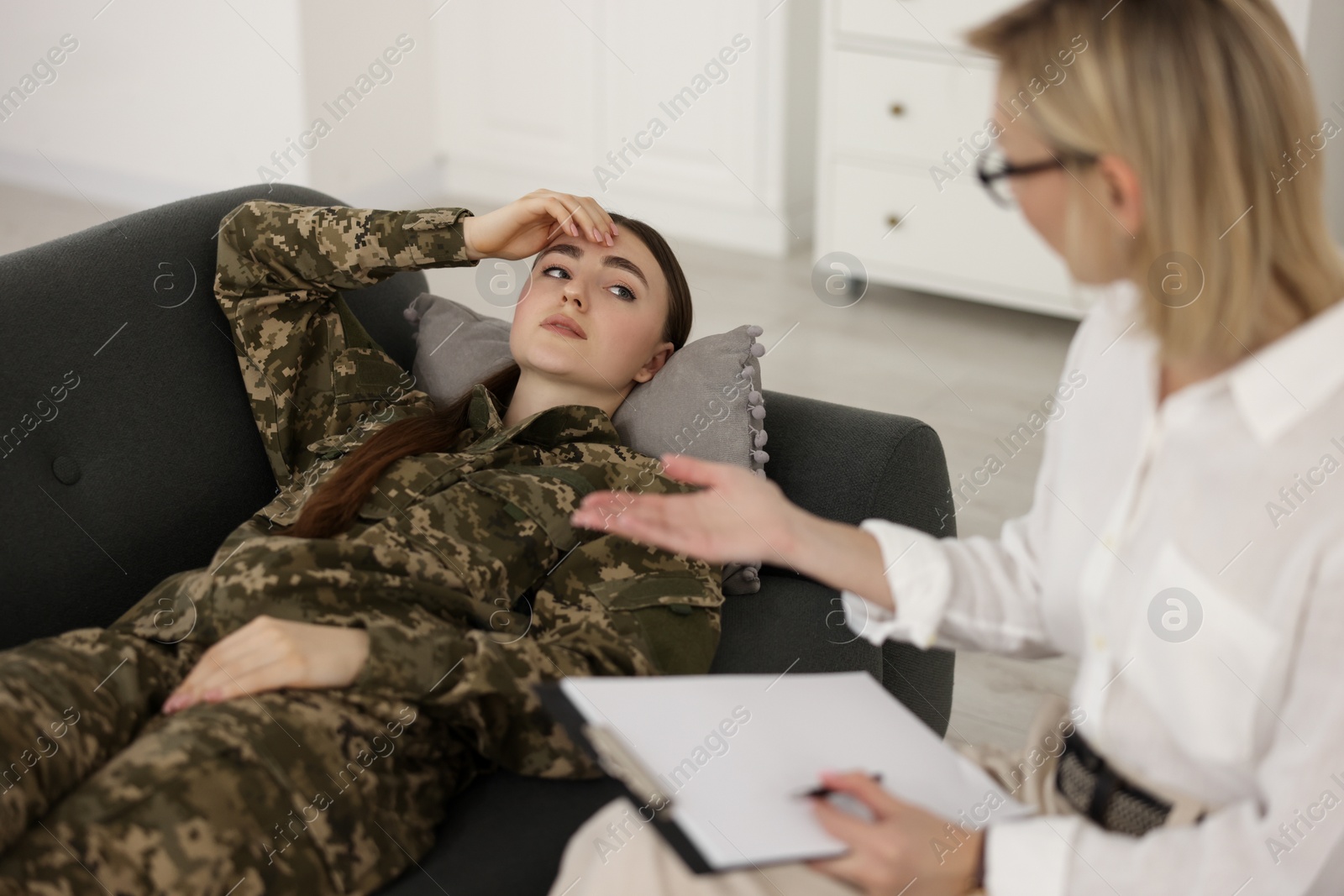 Photo of Psychotherapist working with military woman in office