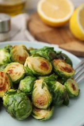Photo of Delicious roasted Brussels sprouts on table, closeup