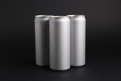 Photo of Energy drinks in cans on black background