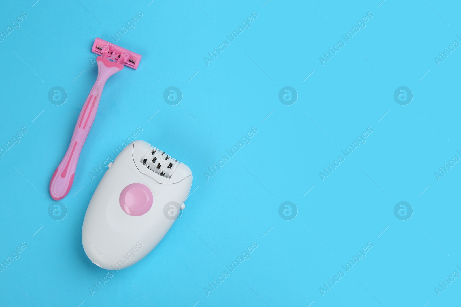 Photo of Modern epilator and razor on blue background, flat lay. Space for text