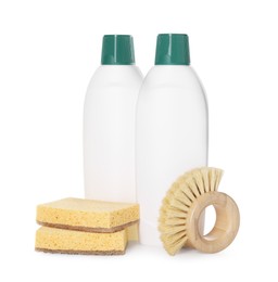 Photo of Bottles of cleaning product, sponges and brush isolated on white