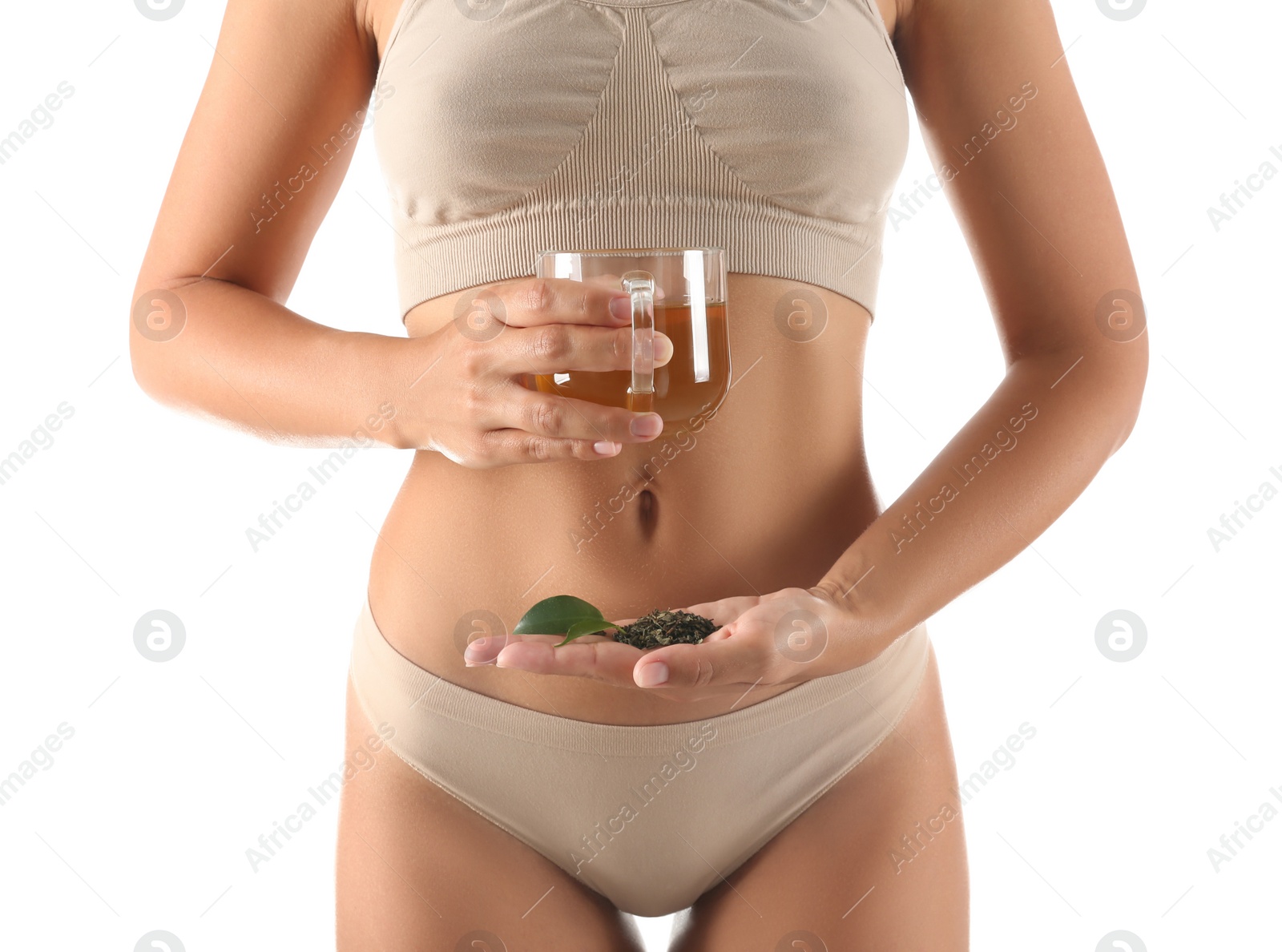 Photo of Young woman holding cup of diet tea, fresh and dry leaves on white background, closeup