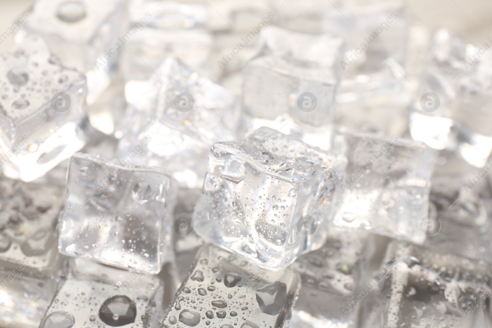 Photo of Melting ice cubes with water drops as background, closeup