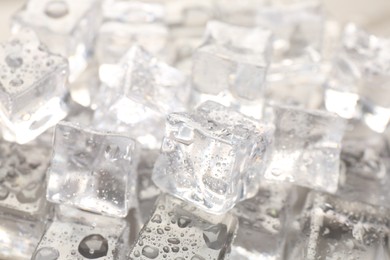 Melting ice cubes with water drops as background, closeup