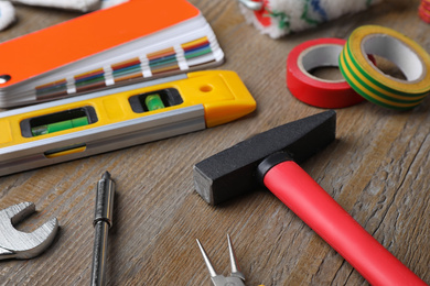 Many different construction tools on wooden table