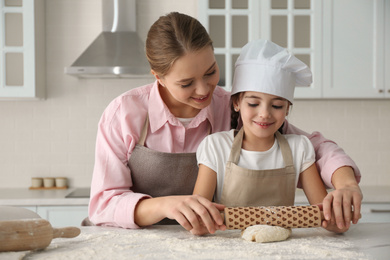 Photo of Mother and daughter cooking together in kitchen
