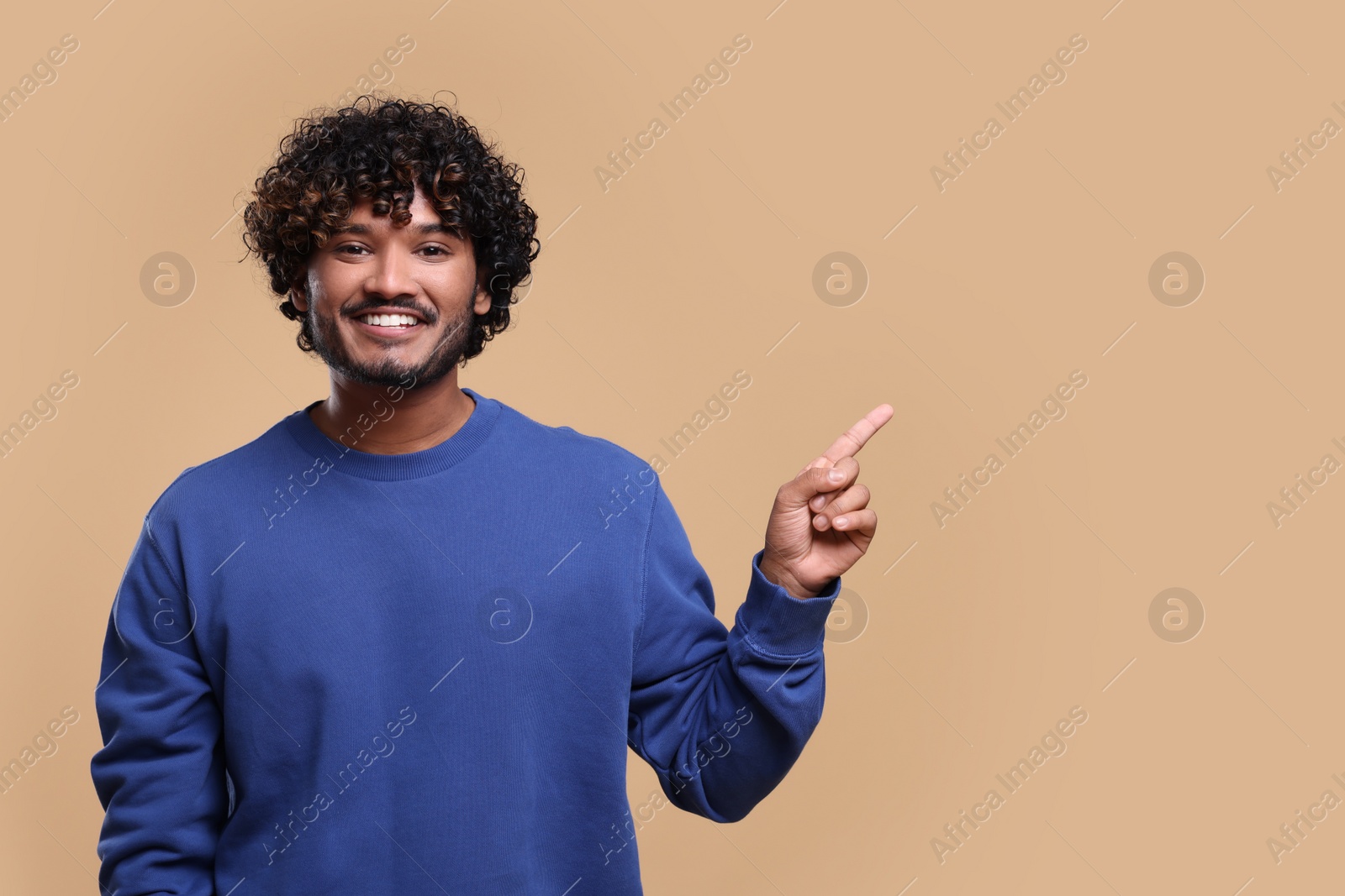 Photo of Handsome smiling man on beige background, space for text