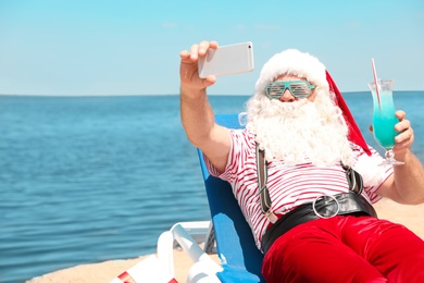 Photo of Authentic Santa Claus taking selfie at resort