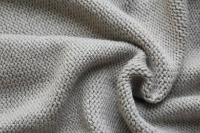 Beautiful grey knitted fabric as background, top view