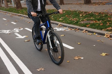 Man with bicycle on lane in city, closeup