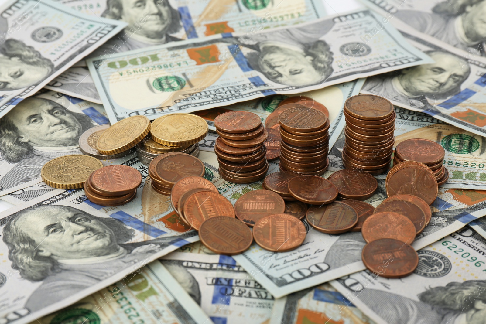 Photo of Stacked coins on American dollar bills, closeup