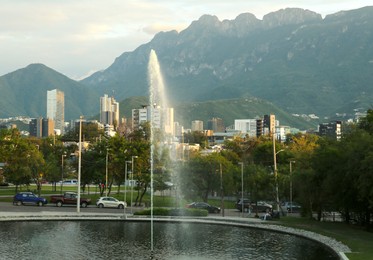 Photo of View of beautiful fountain in park near mountain