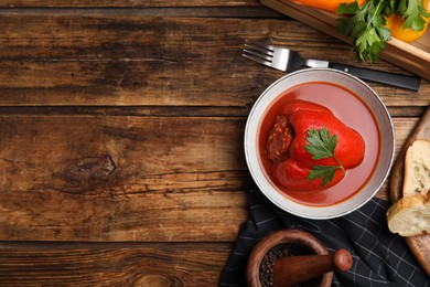 Photo of Delicious stuffed pepper served on wooden table, flat lay. Space for text