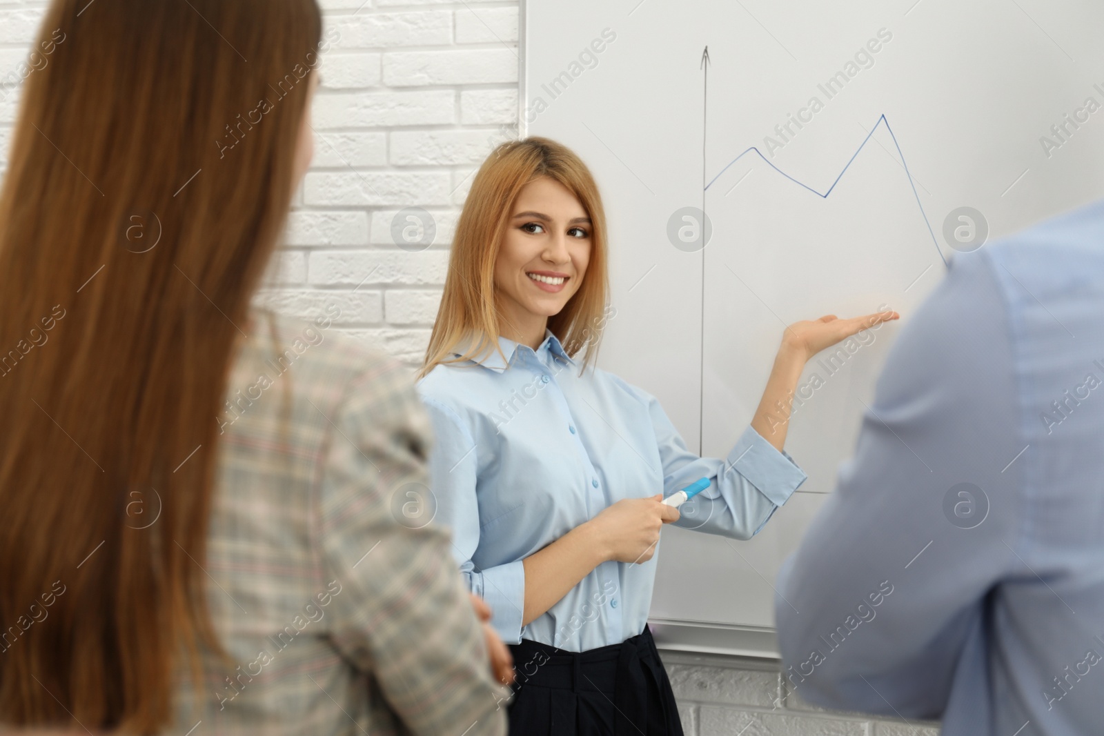 Photo of Professional business trainer working with people in office