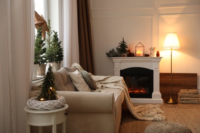 Fireplace in room with Christmas decorations. Interior design