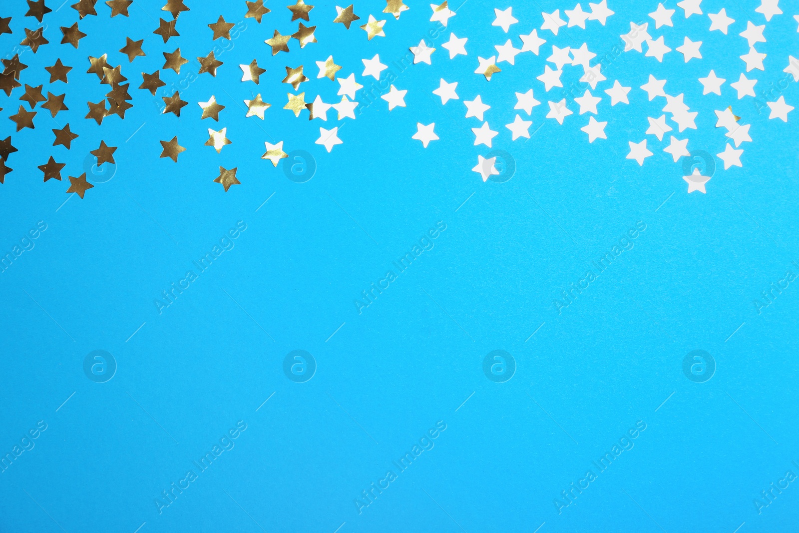 Photo of Confetti stars with space for text on blue background, top view. Christmas celebration