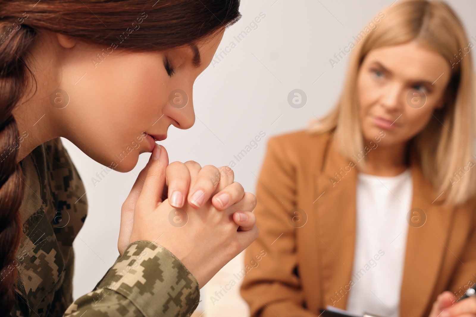 Photo of Psychologist working with military officer indoors, closeup