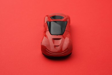 One bright car on red background. Children`s toy