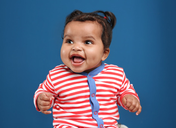 Photo of Cute African American baby on blue background