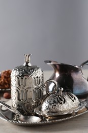 Tray with vintage tea set on wooden table