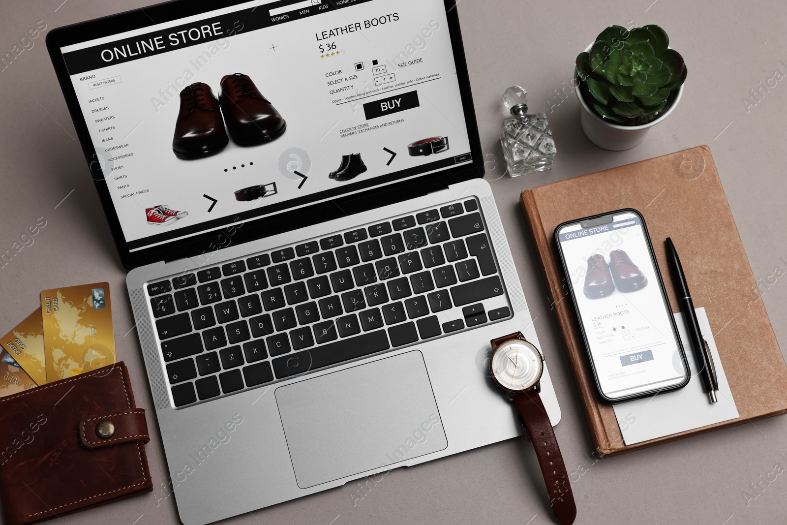 Photo of Online shopping. Composition with laptop on grey background, above view