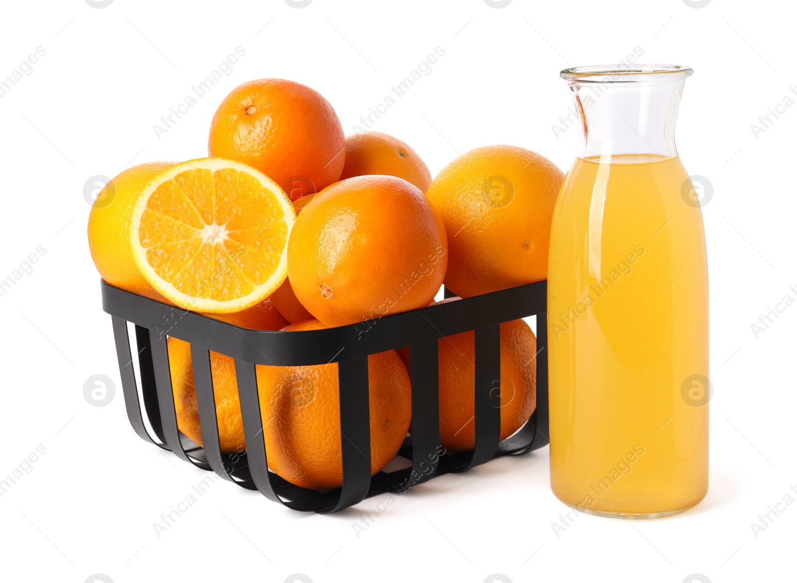 Photo of Fresh oranges in metal basket and bottle of juice isolated on white