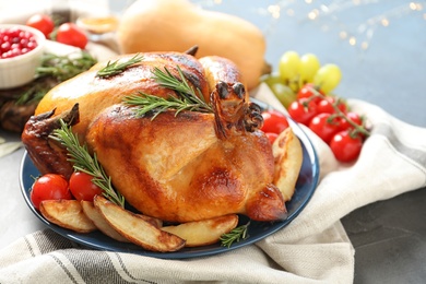 Photo of Delicious roasted turkey for traditional festive dinner on table