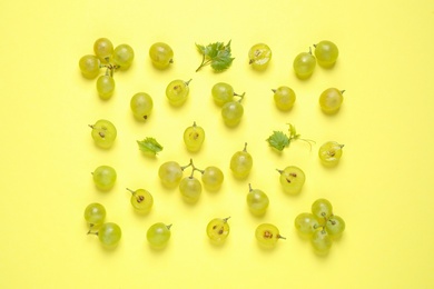 Photo of Flat lay composition with fresh ripe juicy grapes on yellow background