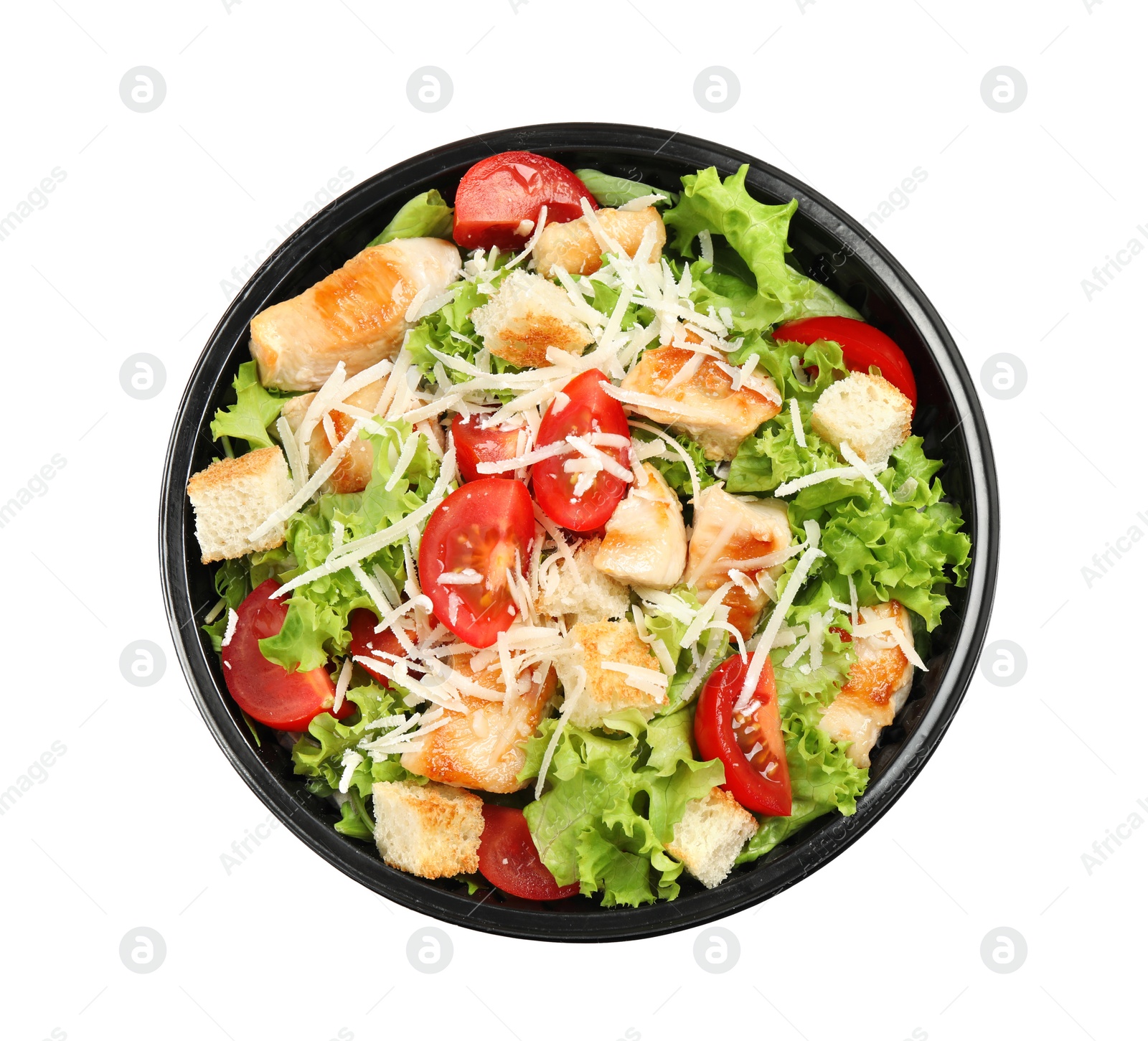 Image of Delicious fresh salad in plastic container on white background, top view