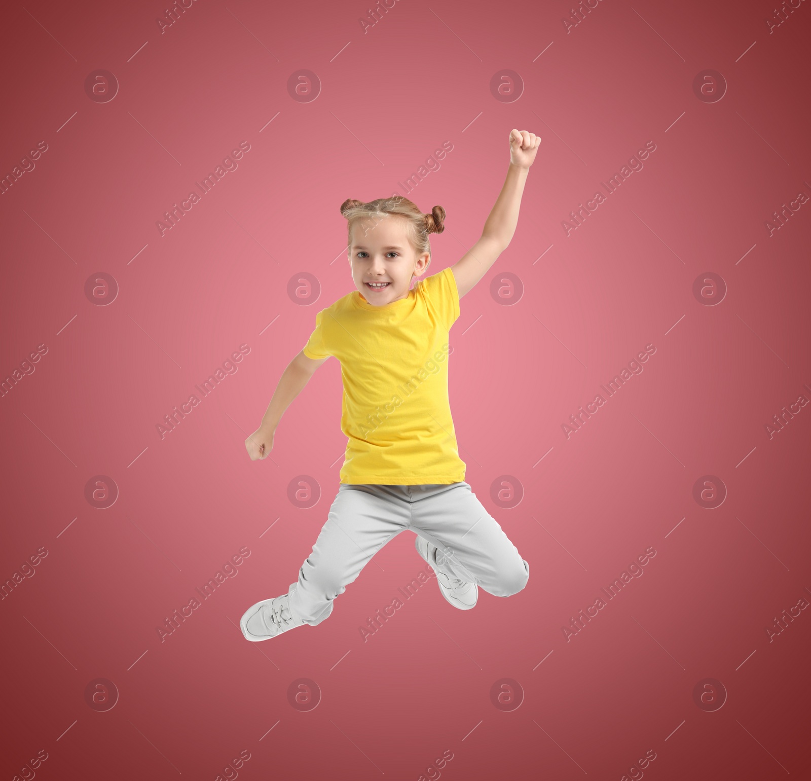 Image of Happy cute girl jumping on color gradient background