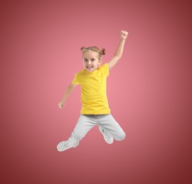 Image of Happy cute girl jumping on color gradient background