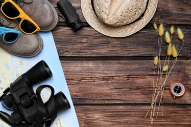 Photo of Flat lay composition with camping equipment on wooden background