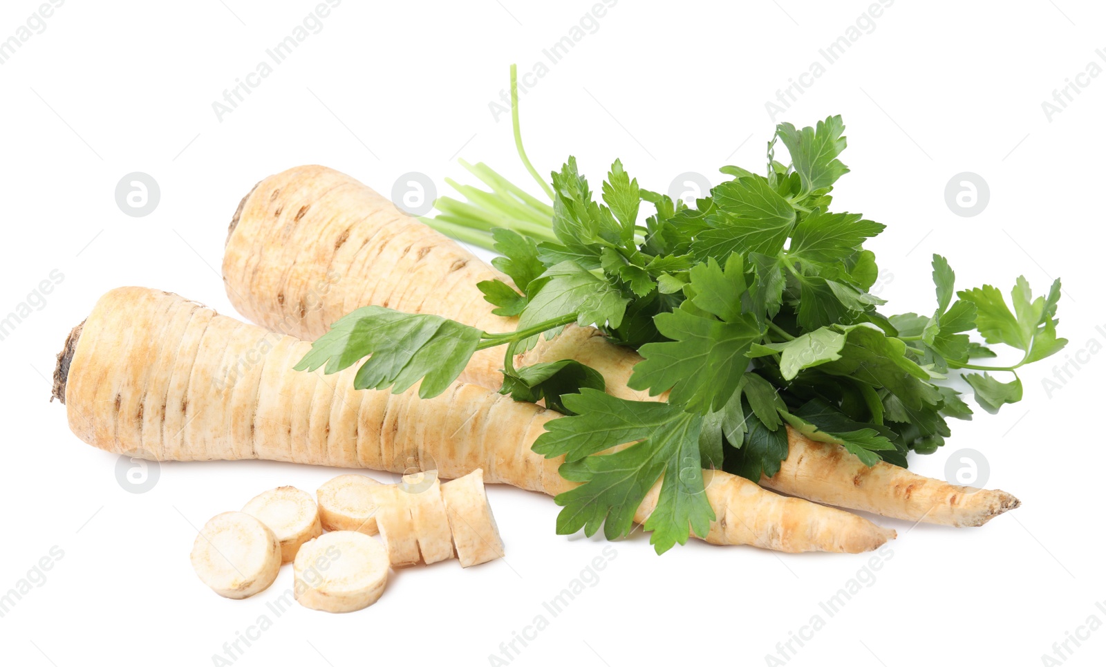 Photo of Raw parsley roots and bunch of fresh herb isolated on white