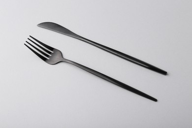 Photo of Stylish cutlery on grey table, above view