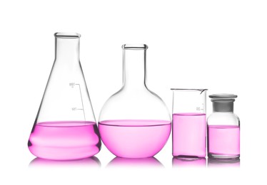 Laboratory glassware with pink liquid isolated on white