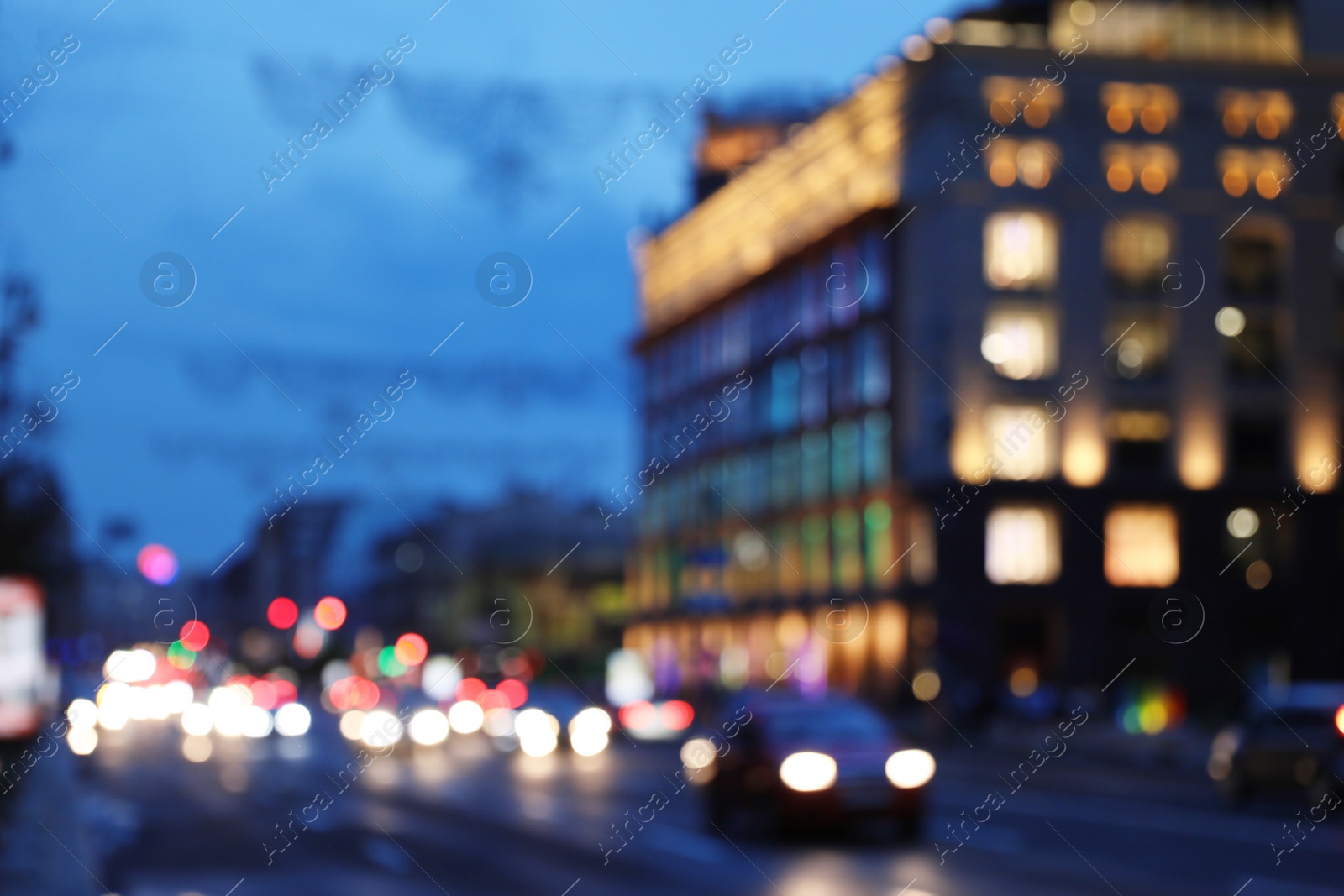 Photo of Blurred view of modern city at evening. Bokeh effect