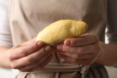 Photo of Woman with piece of fresh ripe durian, closeup