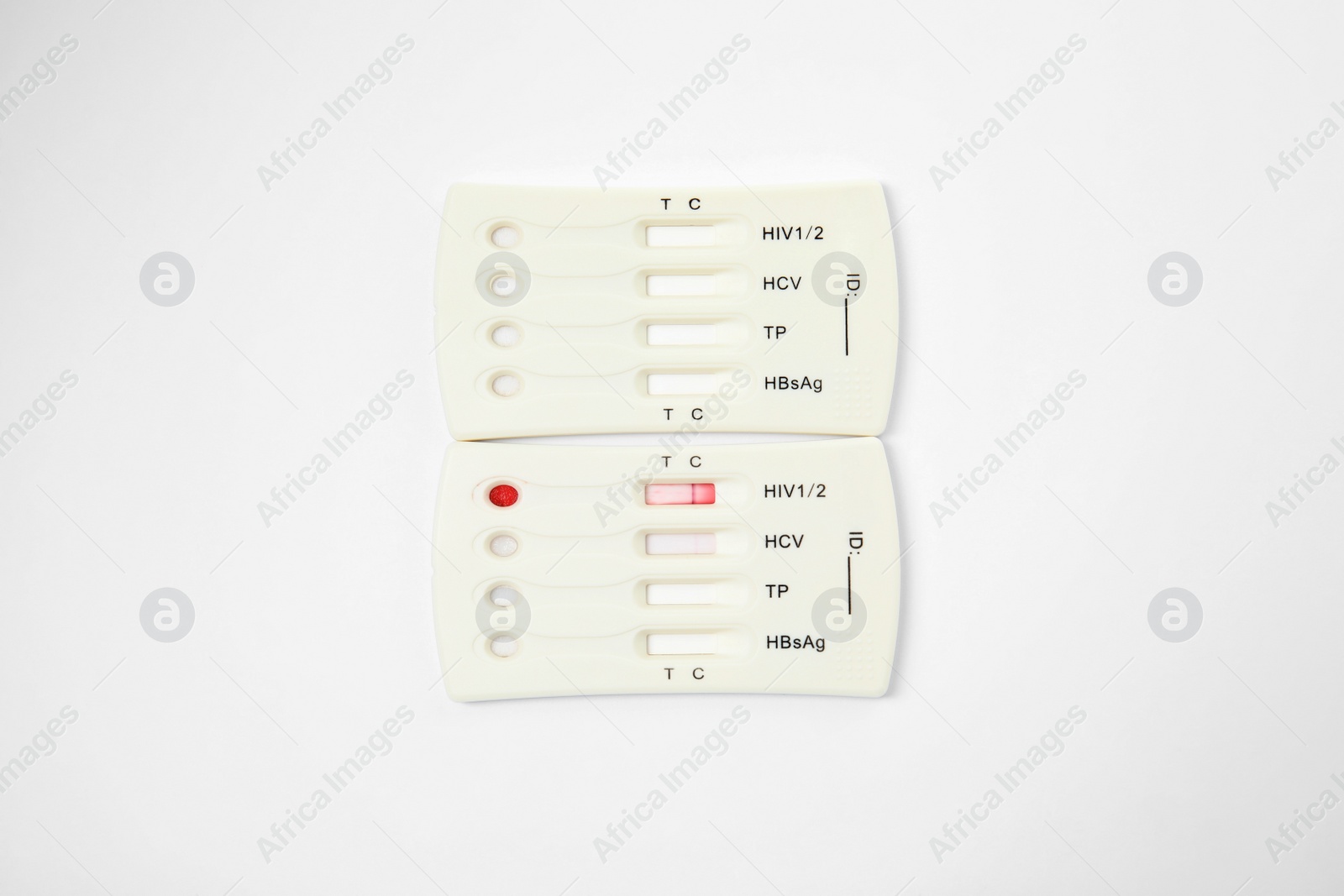 Photo of Two disposable express tests for hepatitis on white background, top view